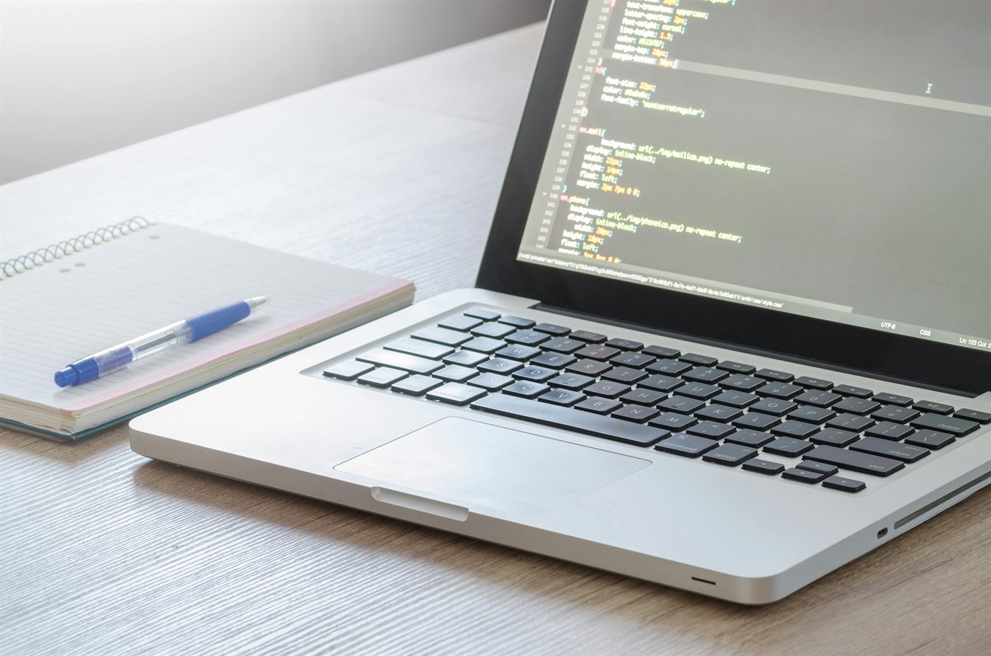 Laptop with web development code for modern website design